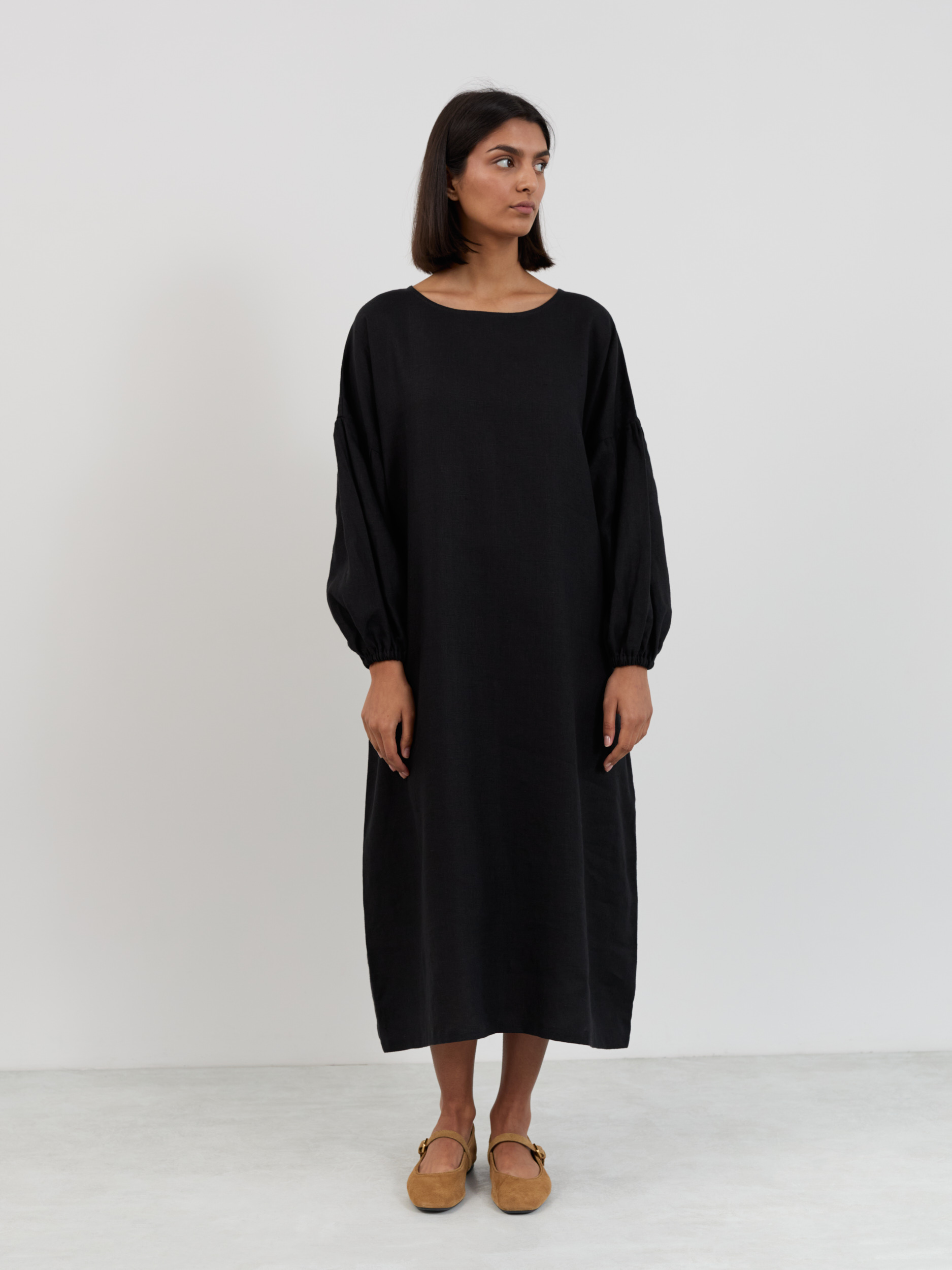 Full front view of the Briar linen midi dress in black showing the straight oversized cut from neckline to mid-calf hem