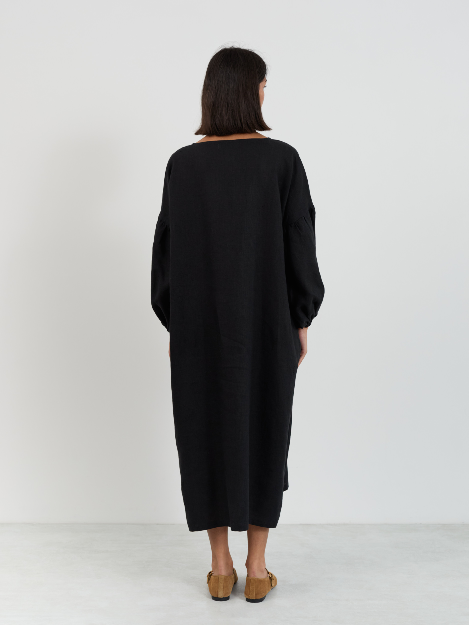 Full back view of the Briar linen midi dress in black showing clean drop-shoulder line and straight relaxed silhouette