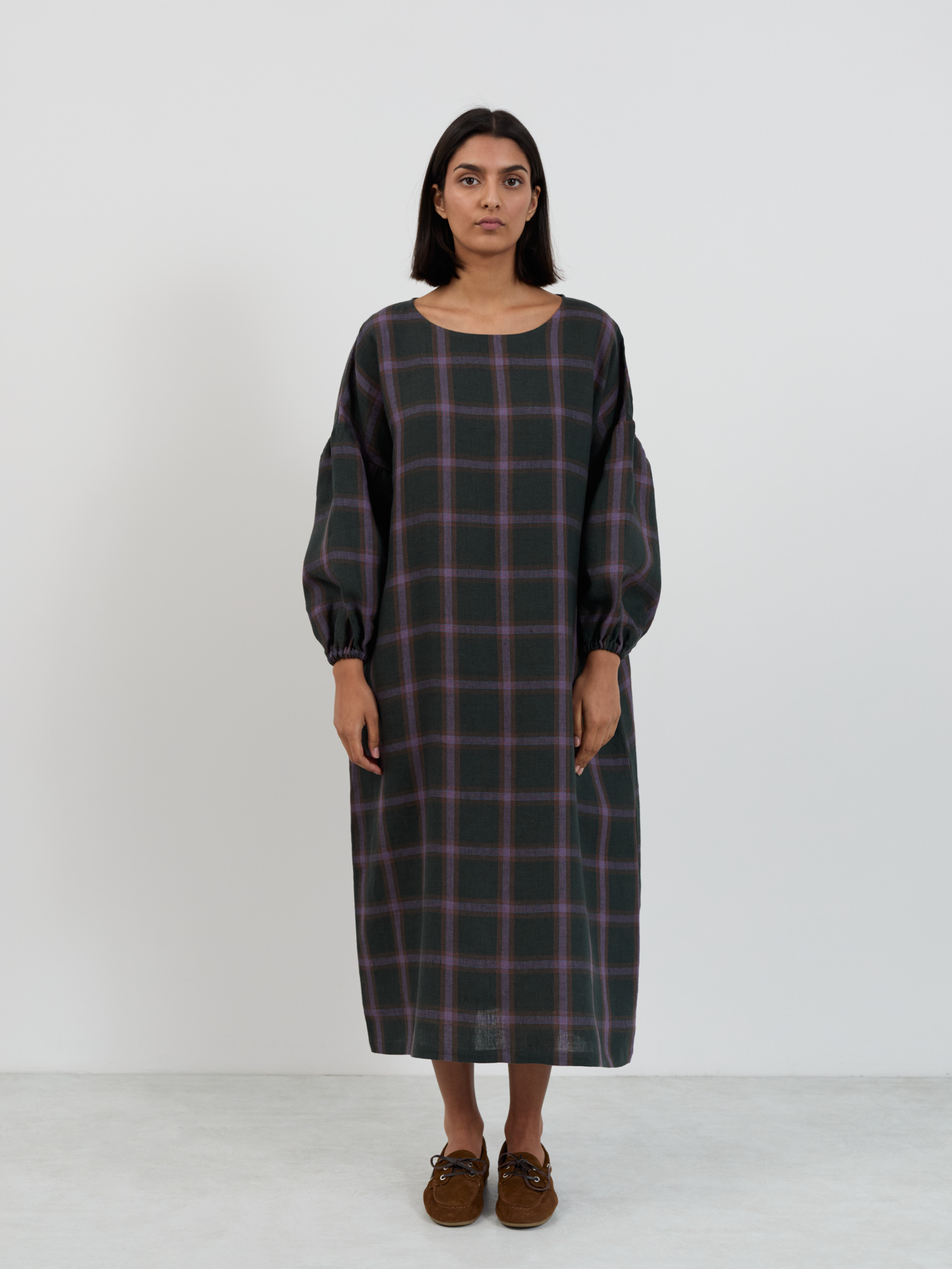Front close-up of the Briar purple plaid midi dress showing windowpane check pattern on dark forest green base with muted purple stripes