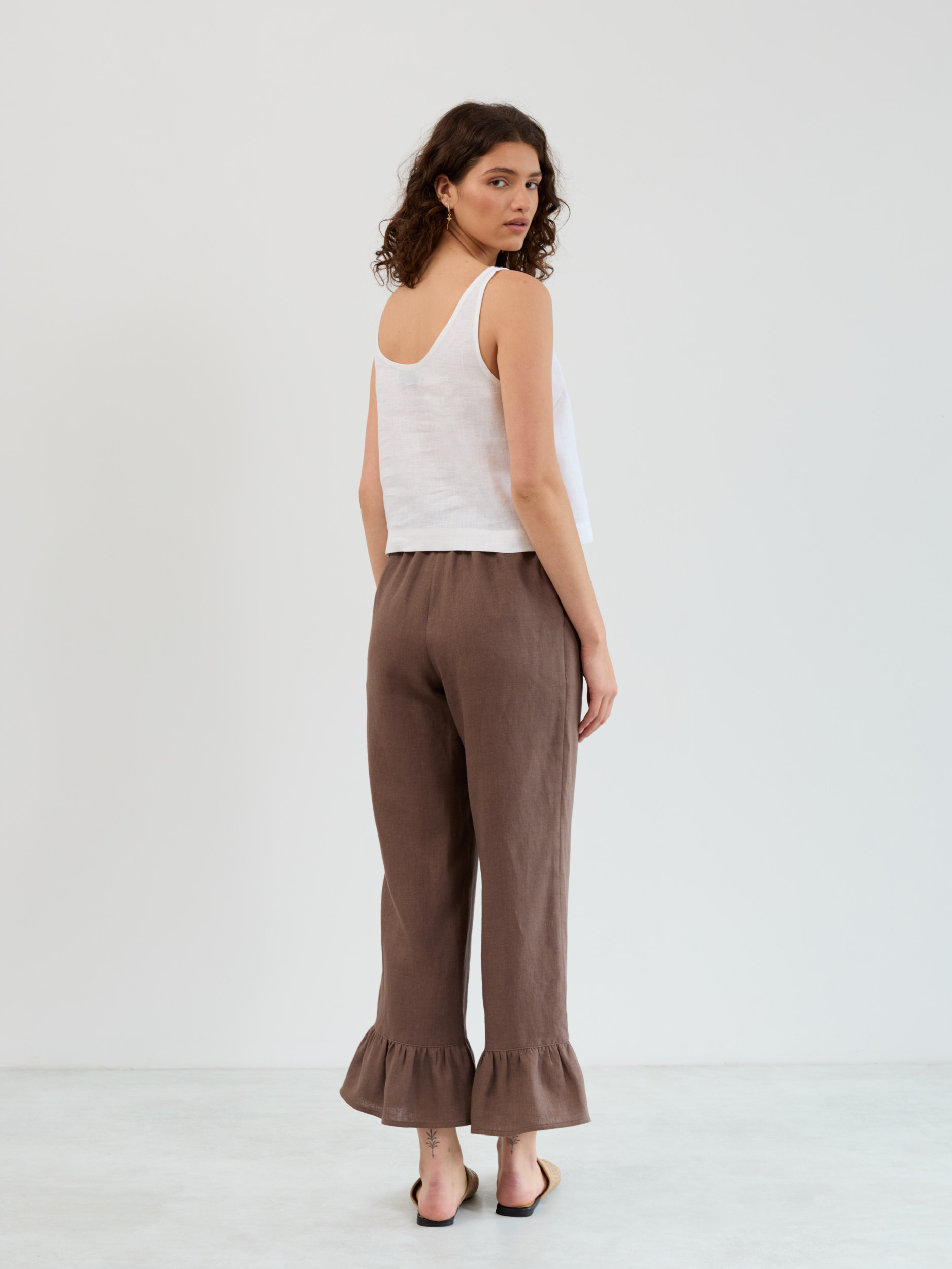 Back view of the Gigi ruffle hem linen pants in cocoa showing the elastic waistband and clean straight leg